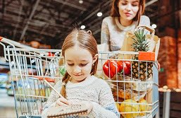 Mulher e filha fazendo compras no supermercado