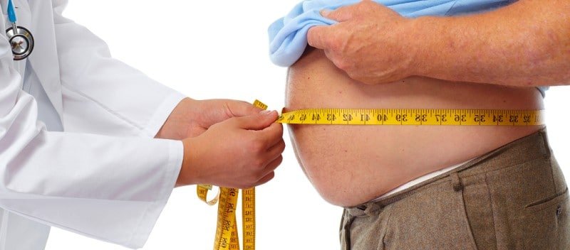 médico medindo barriga de um obeso